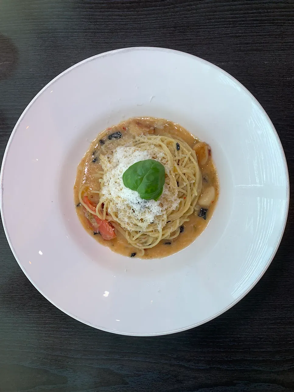A full table of pasta, risotto, and chop steak ordered for two