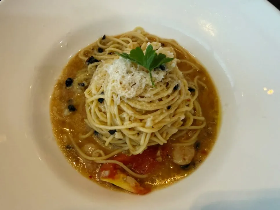 Burrata salad and pasta placed together on the table
