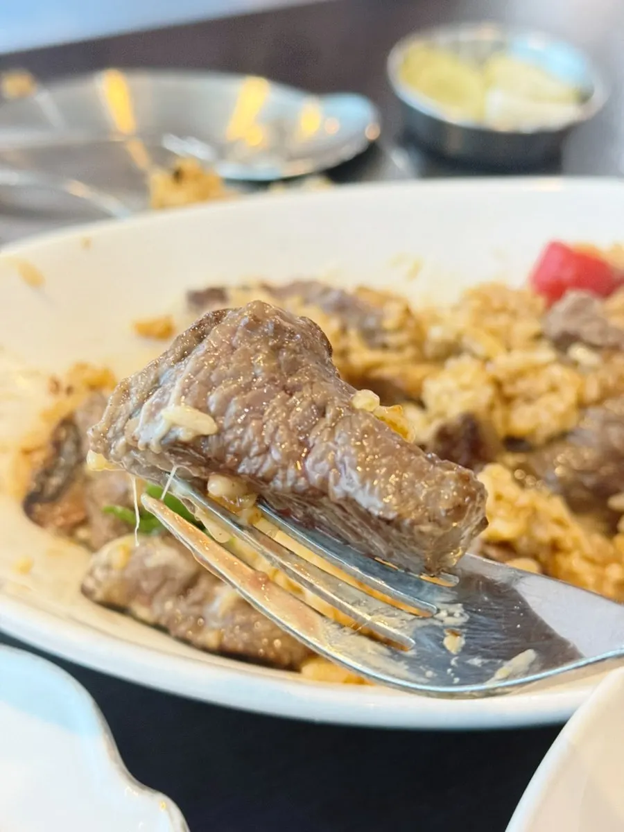 Close-up cross-section of the beef chunks in the pilaf