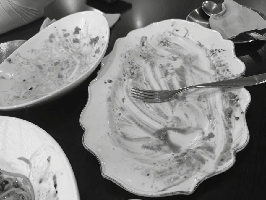 Table after finishing the meal, with the sea visible through the window