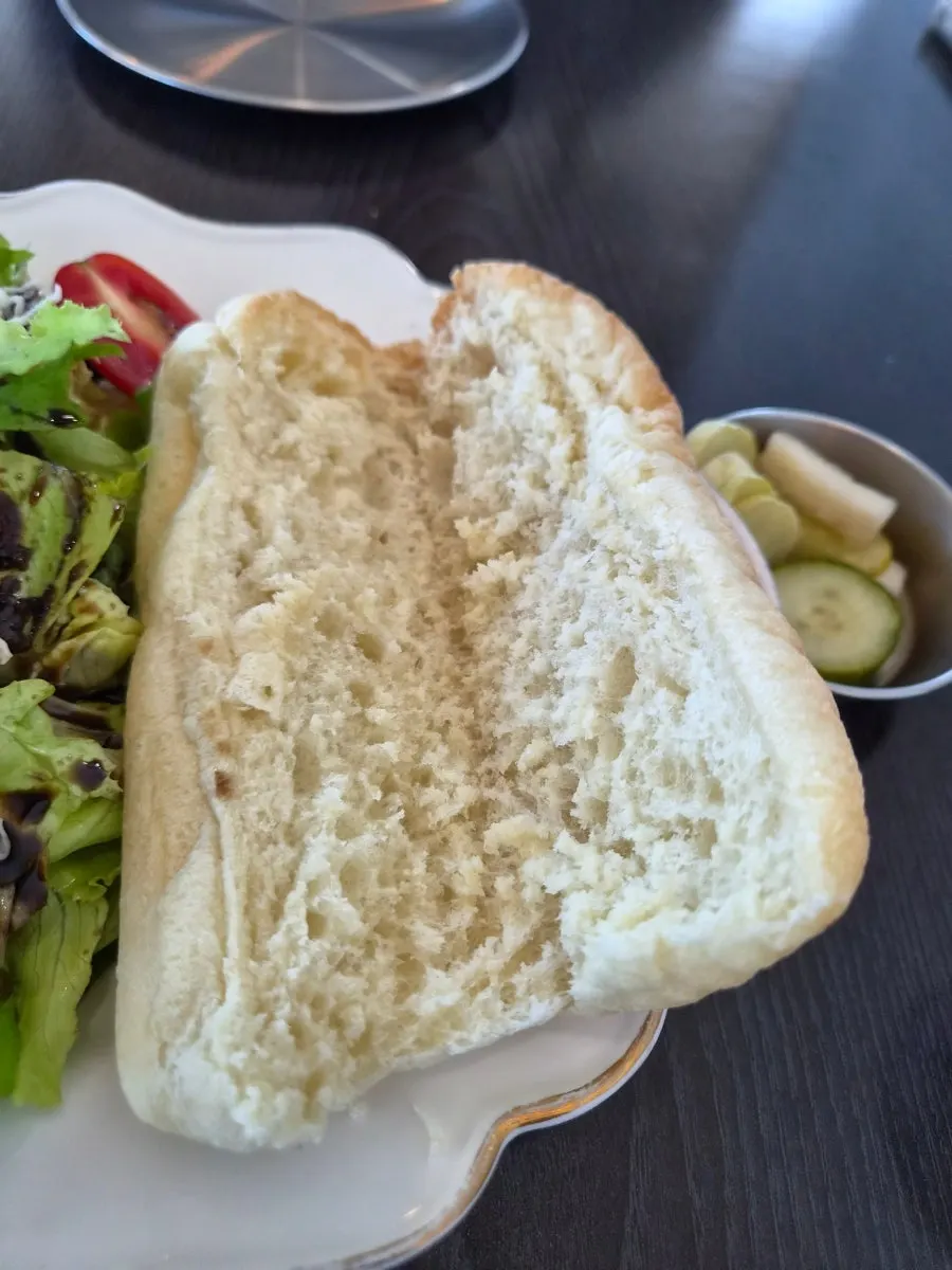 Warm bread served alongside the burrata cheese salad