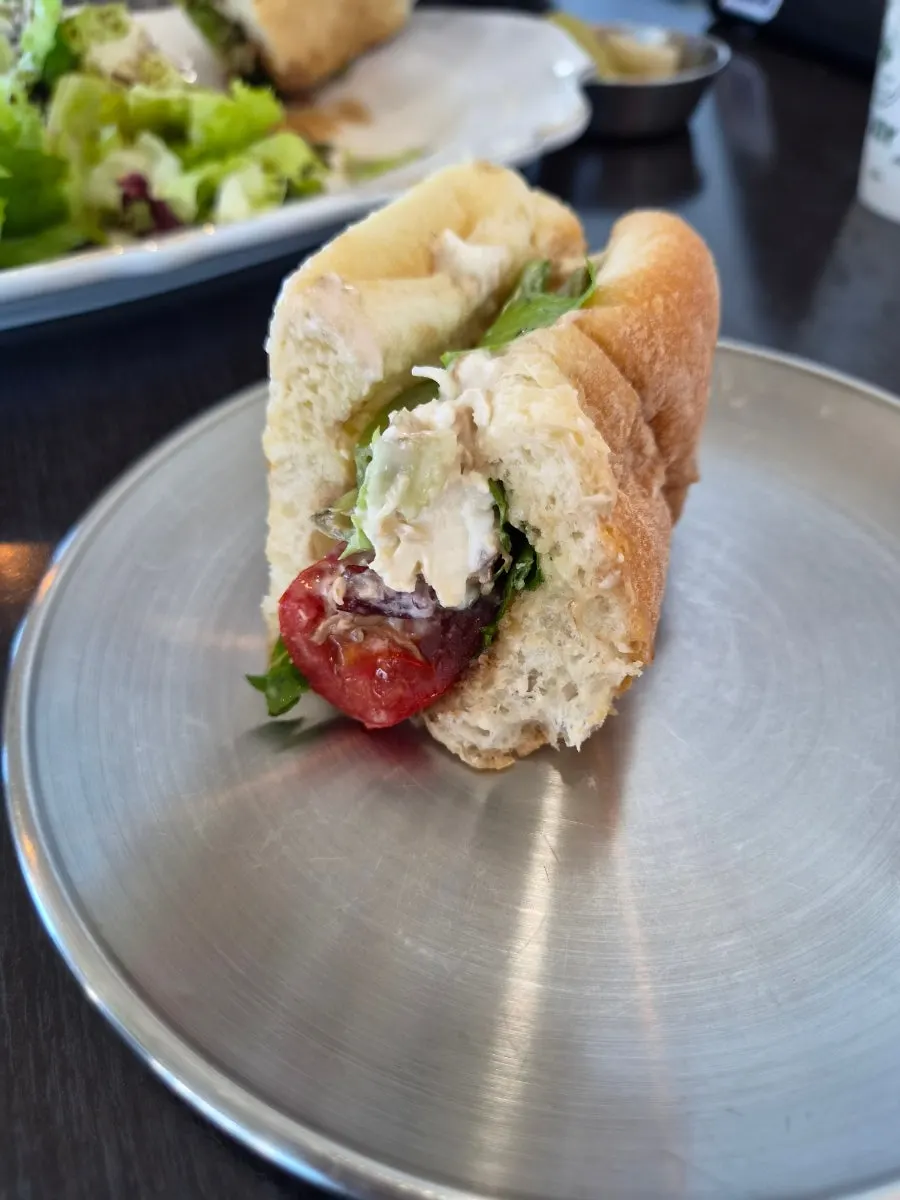 Sandwich made with bread, salad, and cheese