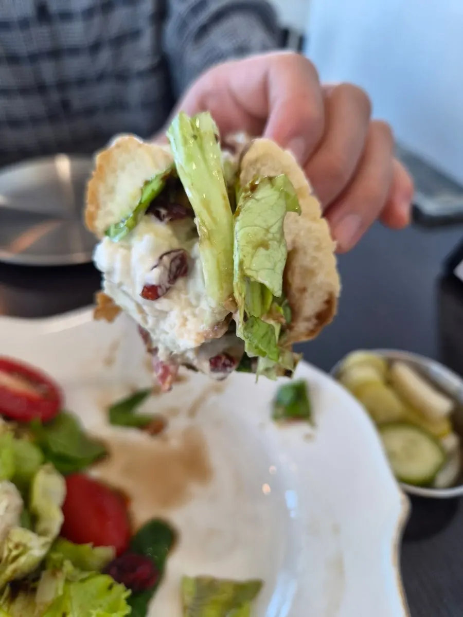Holding the homemade burrata sandwich