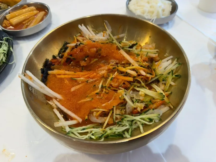 A spoonful of flounder mulhoe lifted from the bowl