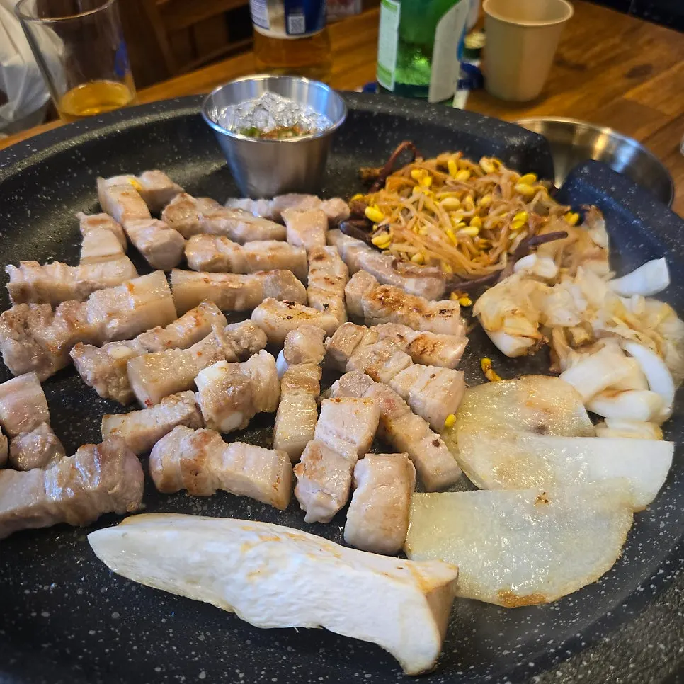 Three servings of ogyeopsal grilling to a golden brown