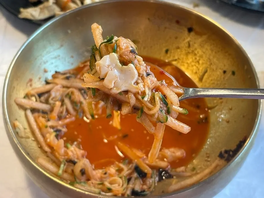 Close-up of Ppwang mulhoe with abalone, sea cucumber, squid, and sea squirt