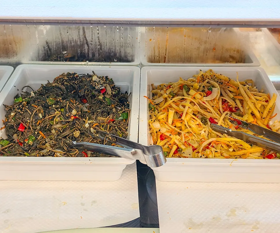 Various side dish containers laid out at the self bar