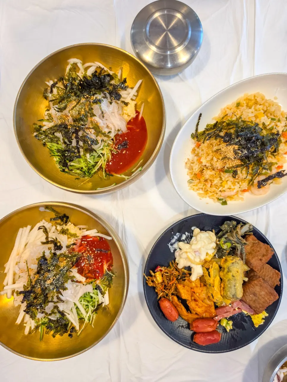 Table with two bowls of mulhoe and shrimp fried rice