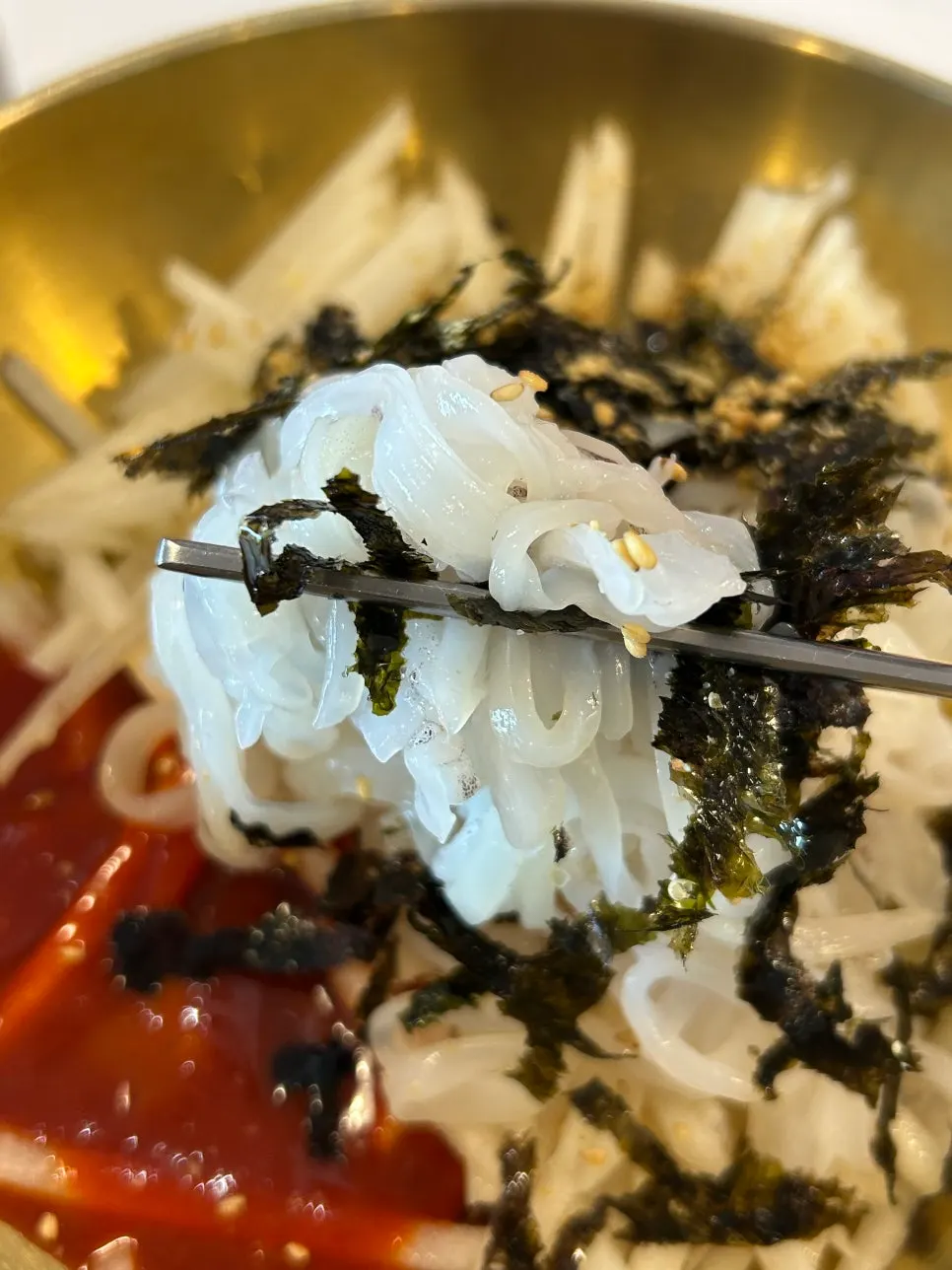 Squid mulhoe finished with rice mixed into the broth