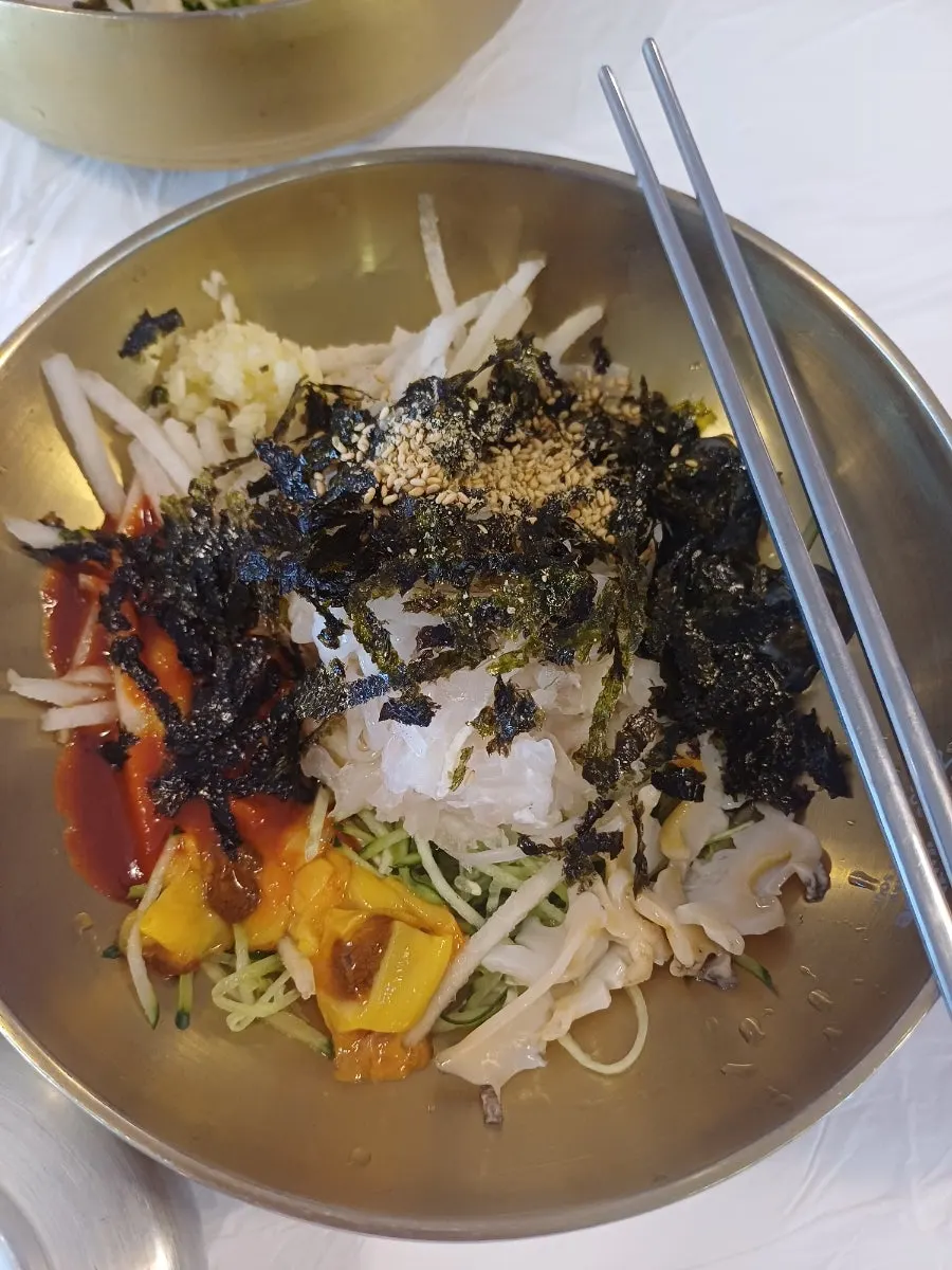 Signature Ppwang Mulhoe topped with abalone, sea cucumber, sea squirt, and squid