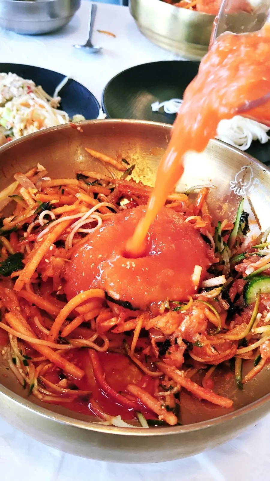 A bowl of mulhoe with the broth poured in