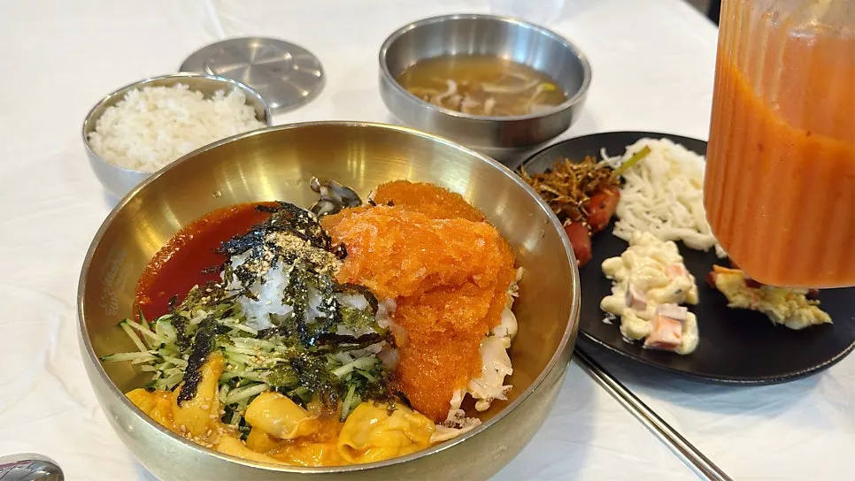 Close-up of Ppwang Mulhoe topped with seafood