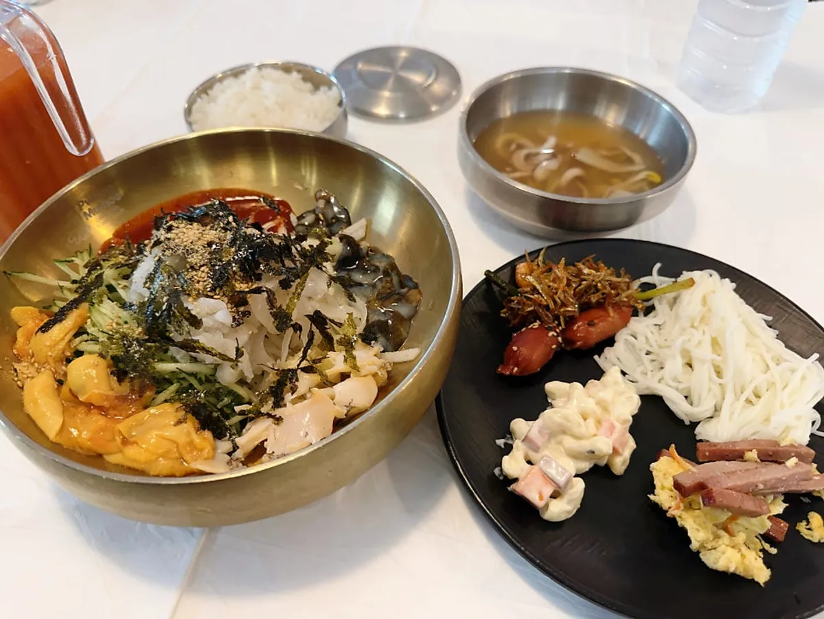 The signature Ppwang Mulhoe topped with abalone, sea cucumber, squid, and sea squirt