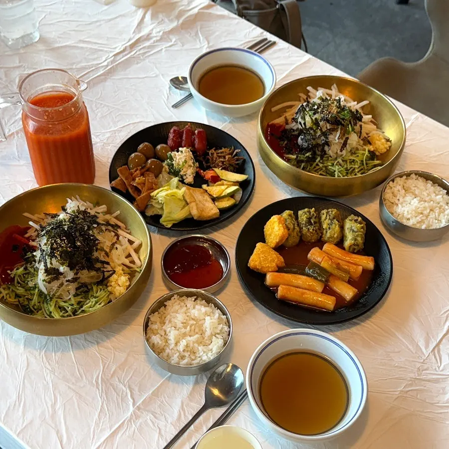 Squid mulhoe and a full spread served in brass bowls