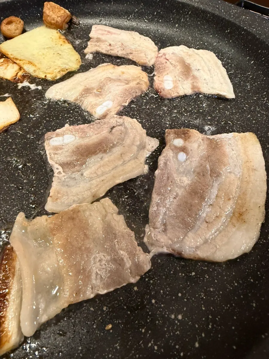 Pork belly browning on the grill