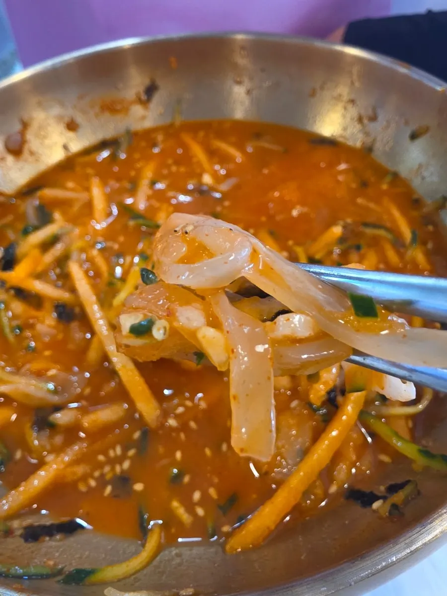 A spoonful of squid mulhoe with cool broth added