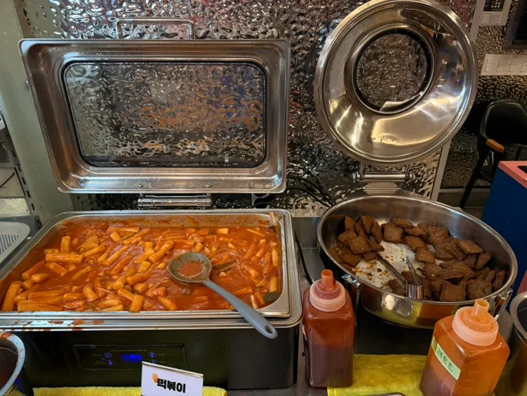 Self-serve bar with Korean side dishes, tteokbokki, and fried snacks