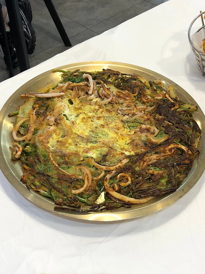Squid pajeon topped with squid over chives