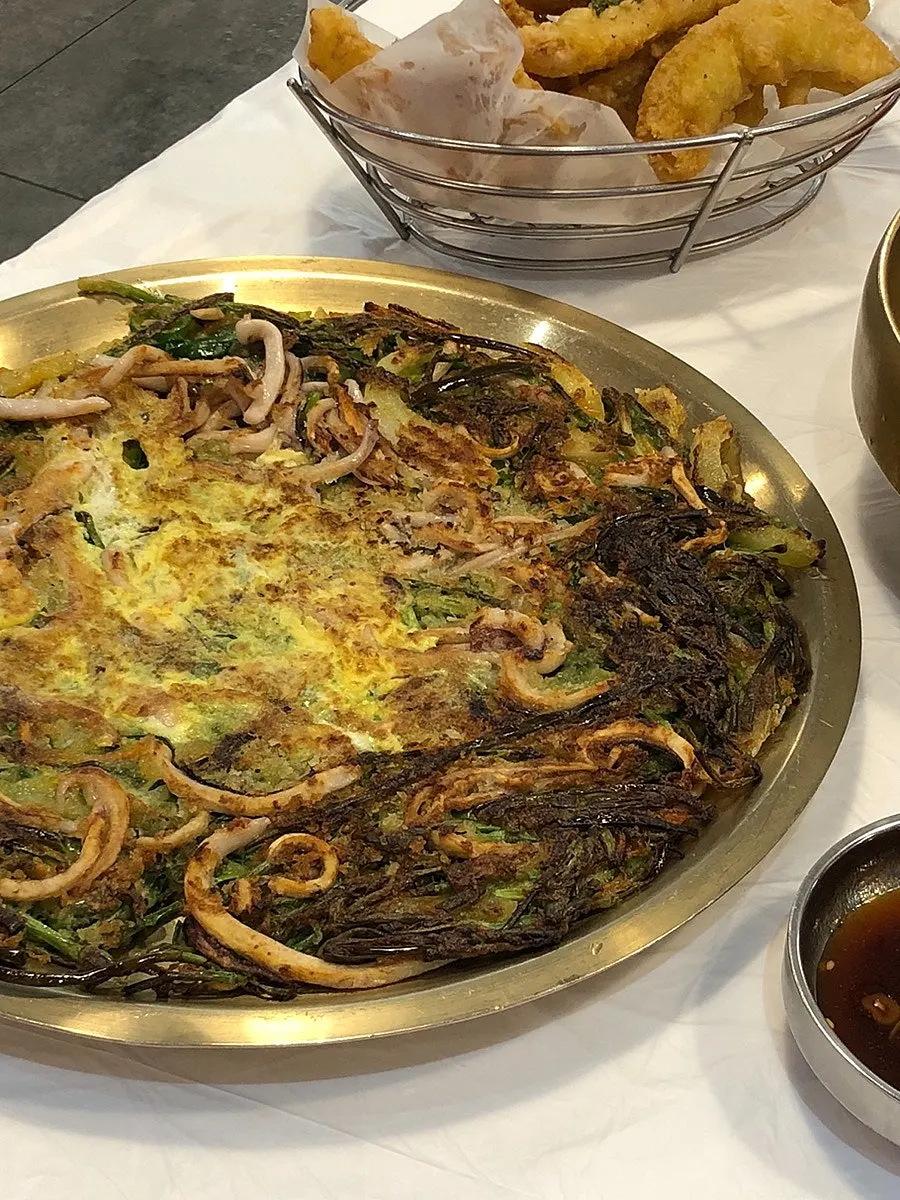 A piece of squid pajeon torn apart with chopsticks