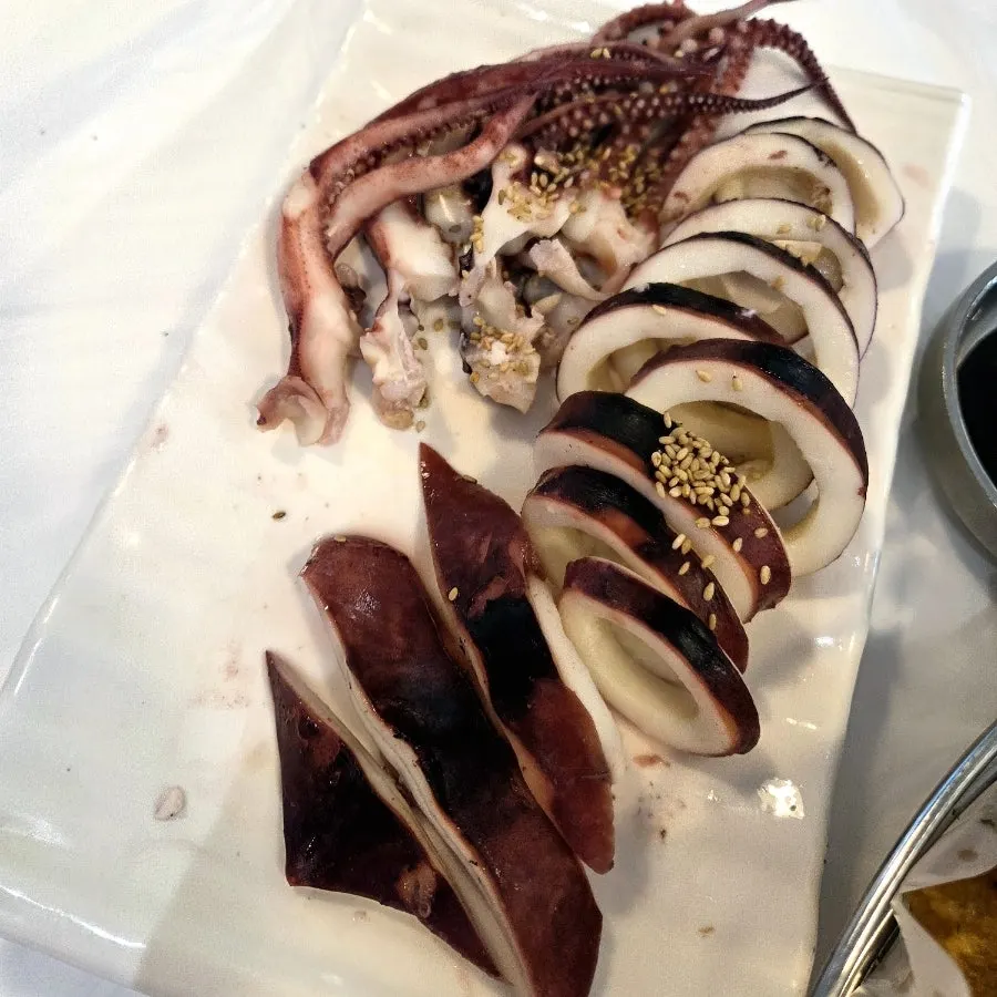 A plate of whole boiled squid with vinegar-chili sauce