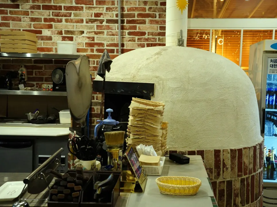 A large wood-fired oven in the open kitchen