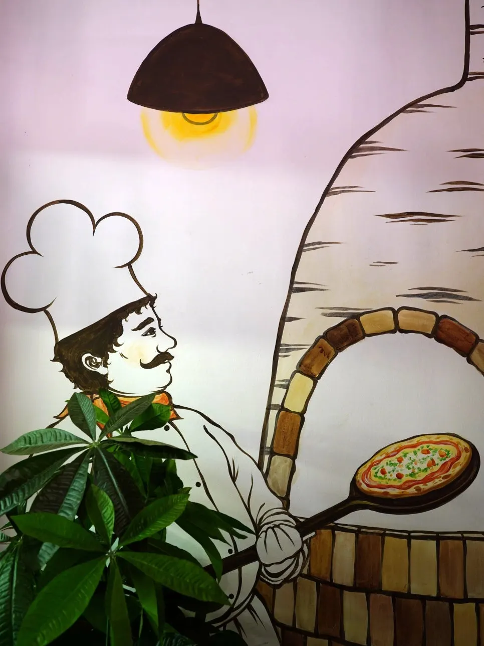 Pizza being baked in the wood-fired oven