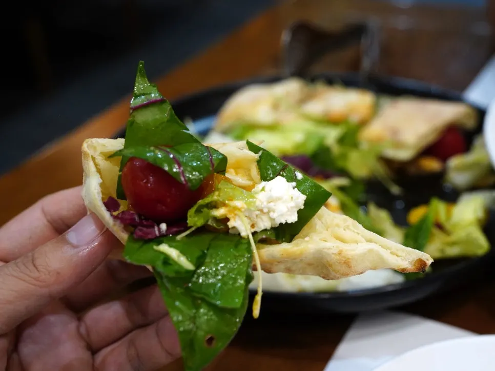 Filling wood-fired gonggalbbang bread with salad