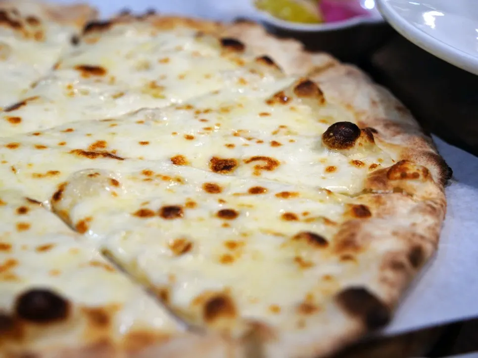 Golden-brown gorgonzola wood-fired pizza