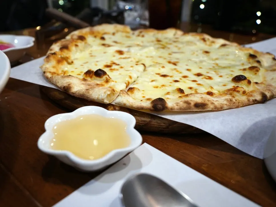 A slice of gorgonzola pizza with stretching cheese