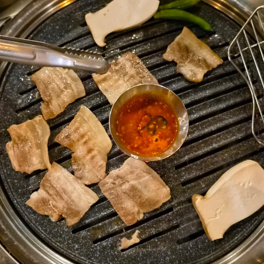 Korean pork frozen samgyeopsal on the grill