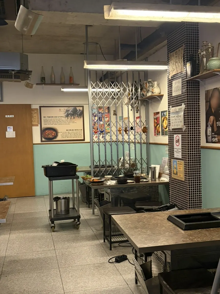 Wide view of Pork80's dining hall with spaced-out tables