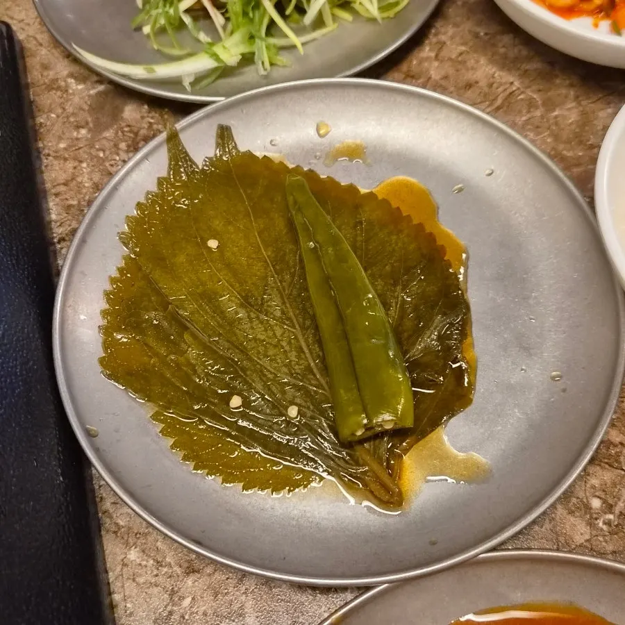 Pickled onions and other side dishes at Pork80