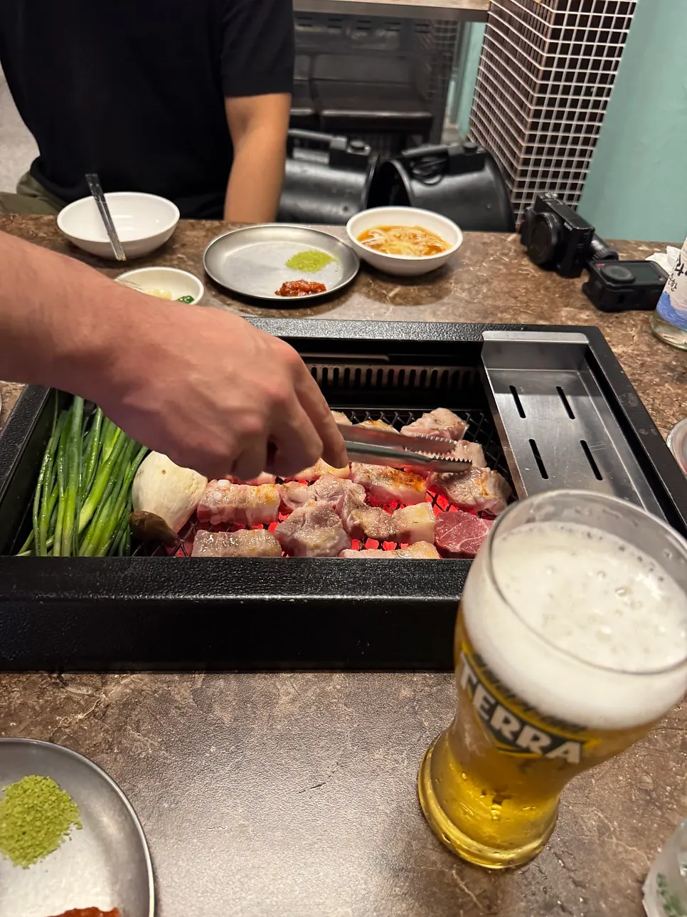 Staff grilling Nanchuk Matdon over charcoal