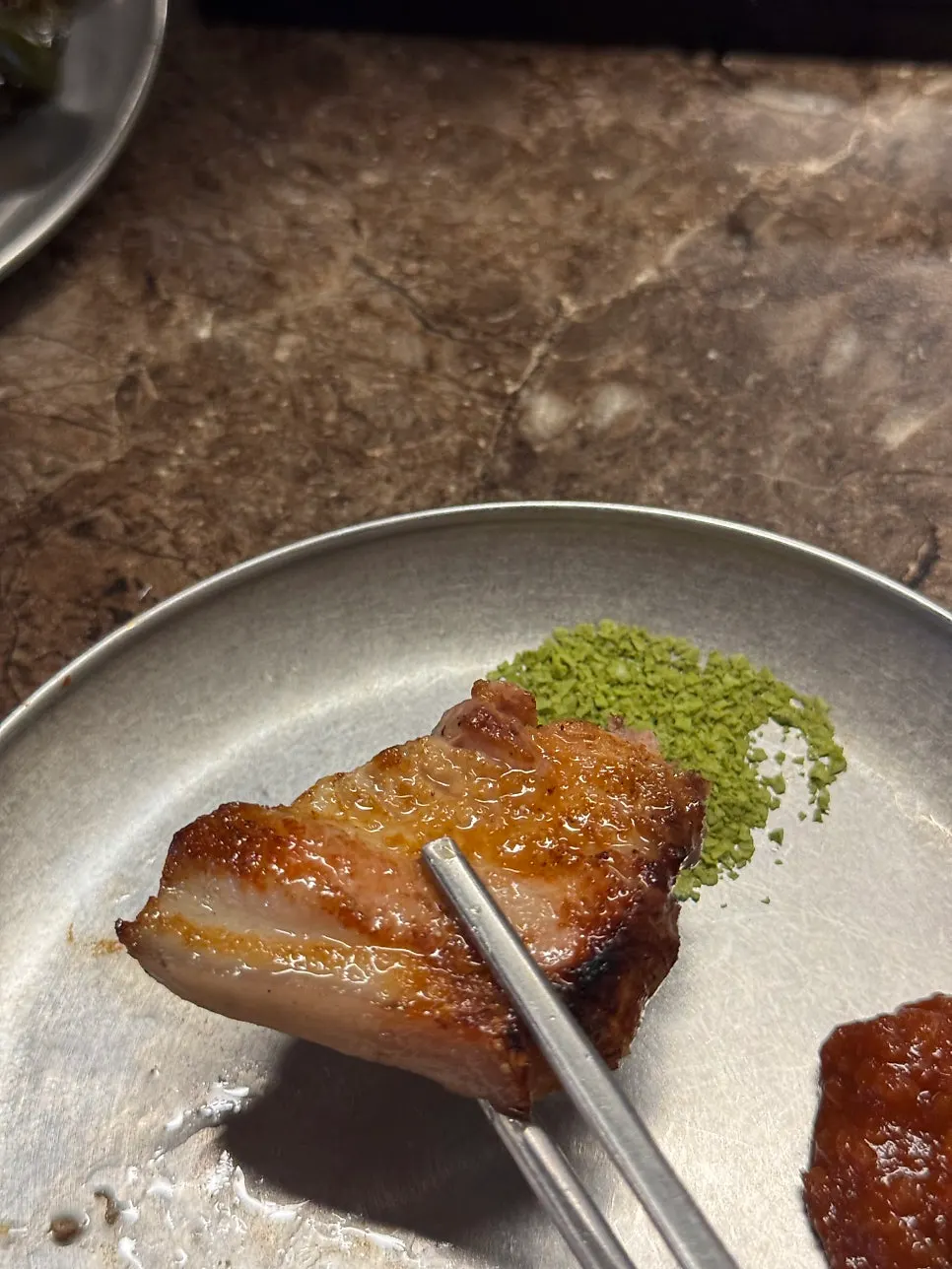 Plate of braised mel and matcha salt side dishes