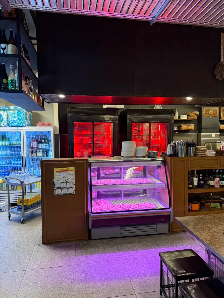 Table and charcoal grilling setup at Pork80 Jeju Airport Branch