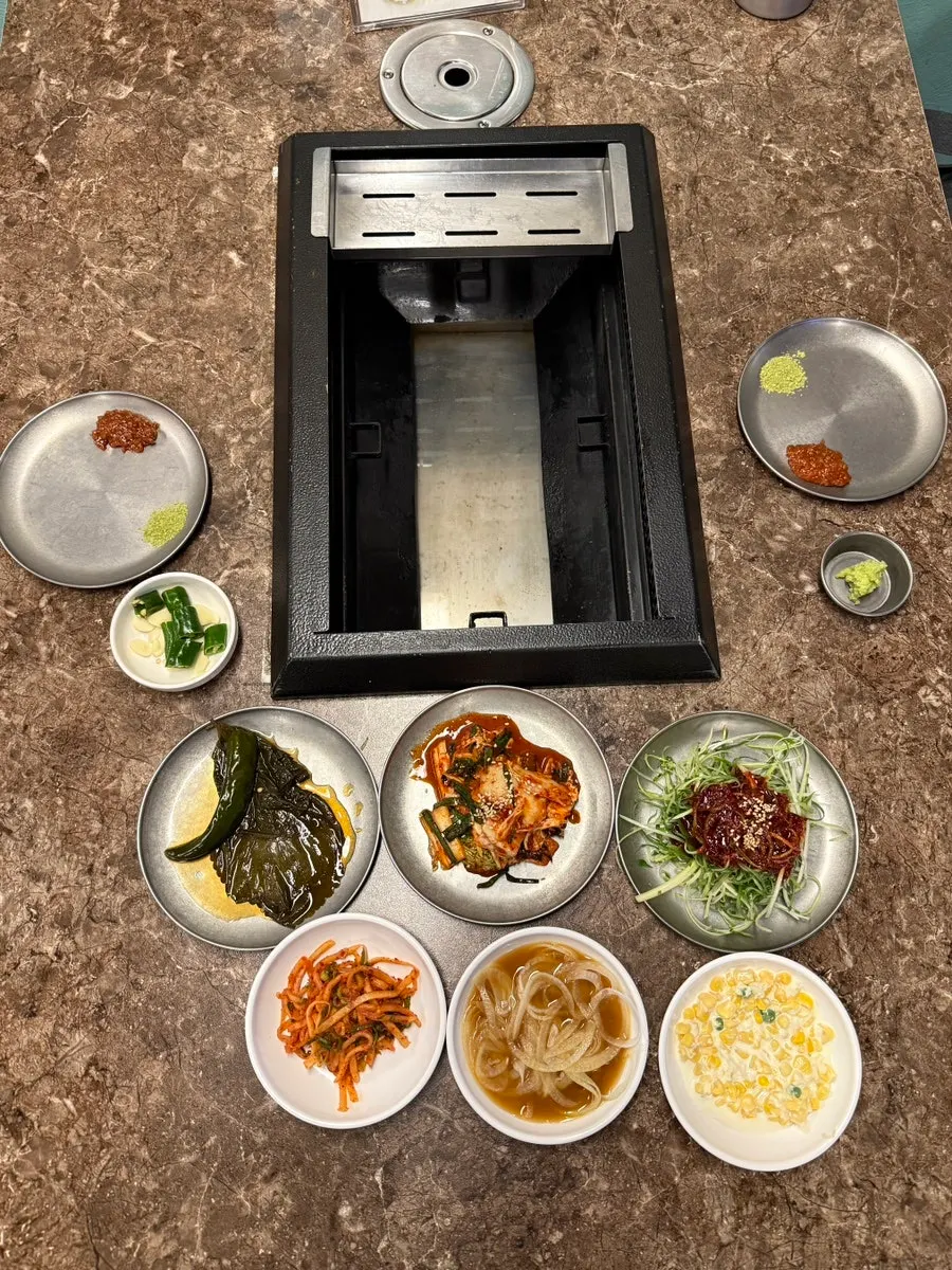 A full spread of basic banchan at Pork80 Jeju Airport Branch