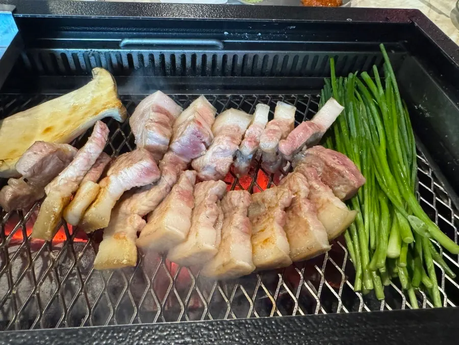 Scallions and pork belly frying in oil