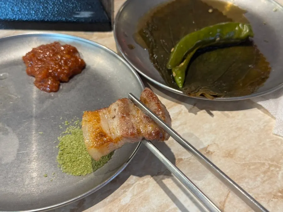 Grilled black pork set aside on a separate grill