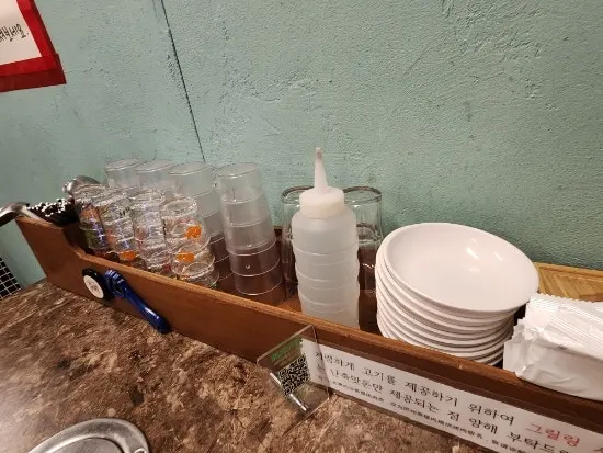 Table setting at Pork80 with side plates, cups, and wet wipes generously laid out