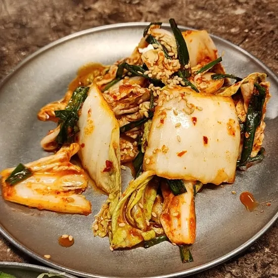 Pickled onions, radish salad, and other side dishes at Pork80
