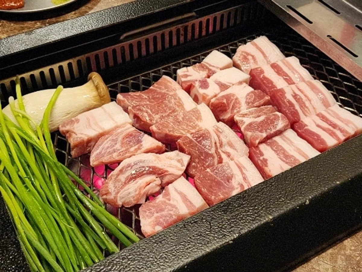 Staff grilling thick cuts of Nanchuk Matdon with scallions
