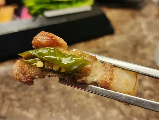 Pickled pepper placed on top of the meat