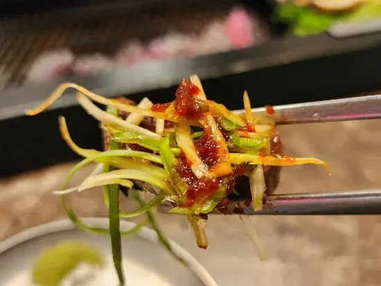 Black pork grilled and eaten with scallion salad