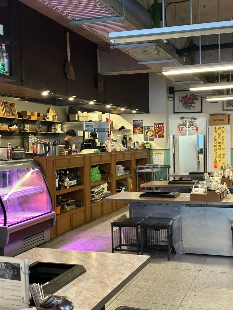 Interior of Pork80 Jeju Airport Branch with generously spaced tables