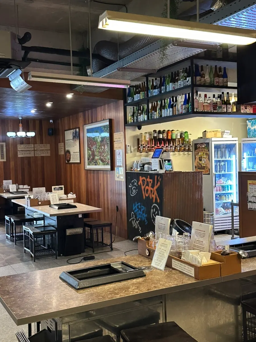 Neatly arranged dining hall seating at Pork80 Jeju Airport Branch