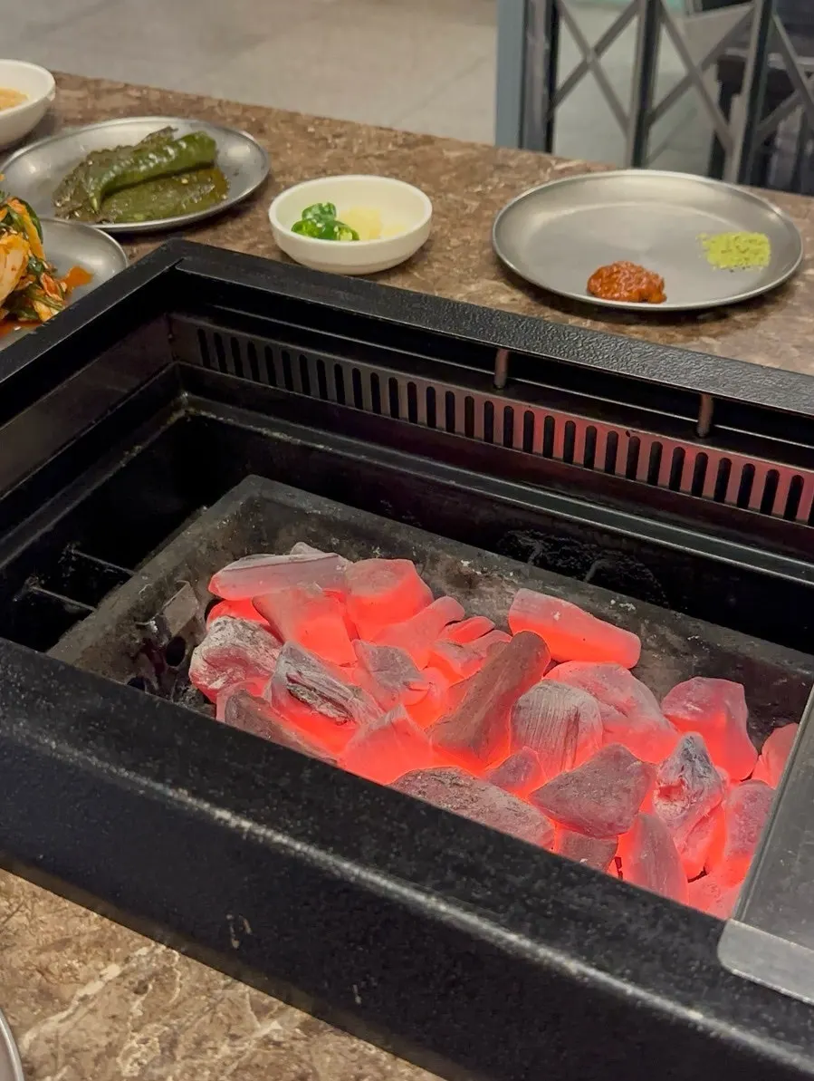 Black pork placed on a grill with strong charcoal heat