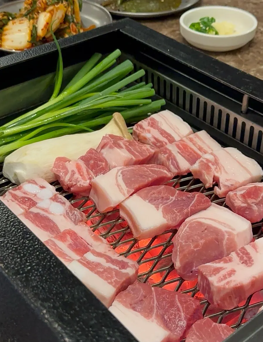 Nanchuk Matdon black pork grilling over charcoal