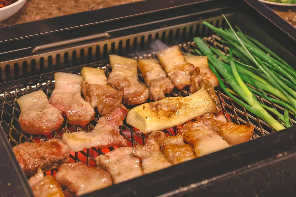 Staff grilling Nanchuk Matdon over charcoal