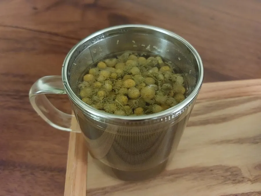 Chamomile tea and dessert placed under soft lighting