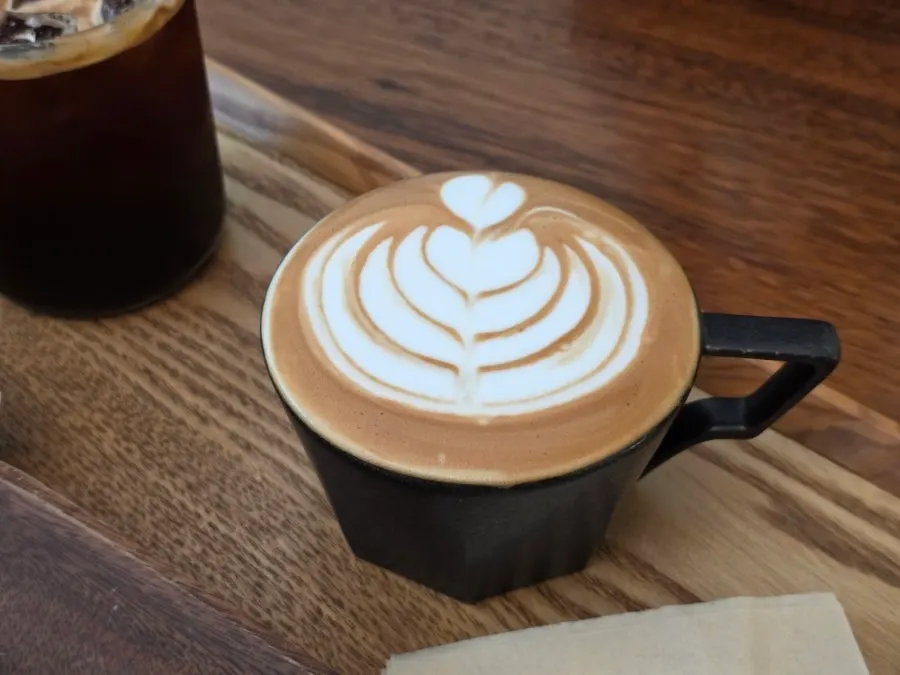 Coffee and cake on a table by the forest-view window